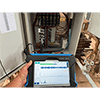 A photo of a data collector taking a reading from the BNC on the front of a CTC SC300 Series Signal Conditioners.
