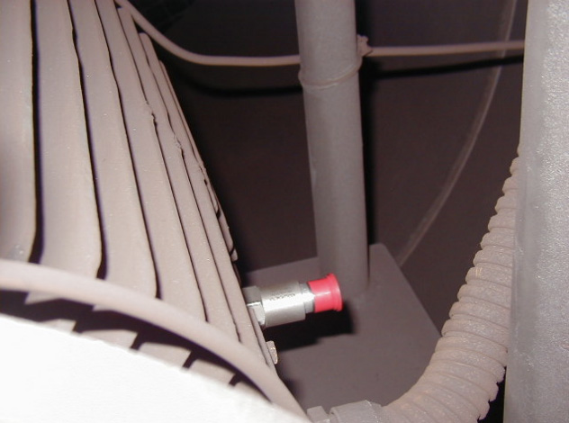 A CTC top exit sensor with red sensor cap mounted horizontally on a motor fin.