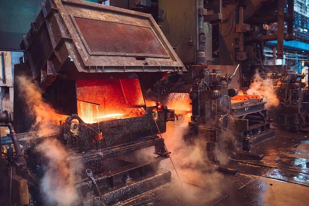 Molten steel on industrial conveyor inside a steel mill