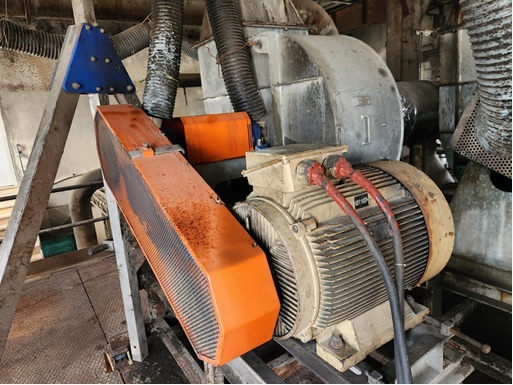 Photo of a belt-pulley driven fan inside a paper mil