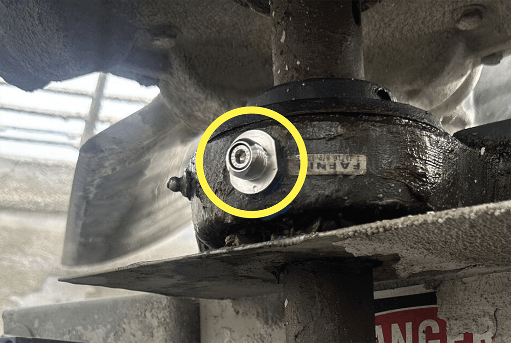 A photo of a CTC quick disconnect stud through-mounted on an industrial machine.