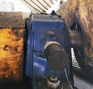 A photograph of a ConnectSens wireless sensor mounted on a belt-pulley driven fan