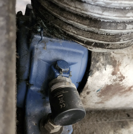 A photo of a CTC ConnectcSens Wireless sensor mounted on the pulley side of a vacuum fan.