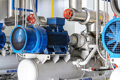 A large blue compressor on an industrial refrigeration unit.